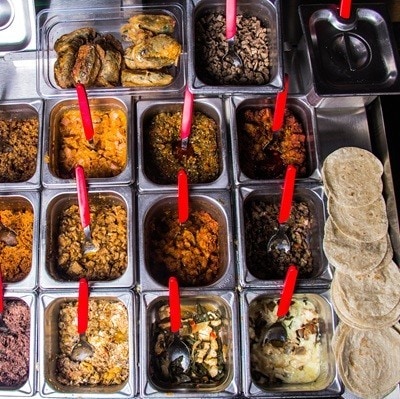 An arrangement of taco filling ingredients displayed in metal containers, ready for assembly, showcasing the rich variety of flavors in Mexican cuisine.